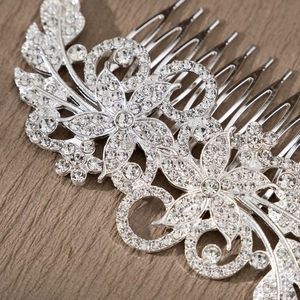 Macro detail of silver alloy floral hair comb with sparkling rhinestones for bridal styling
