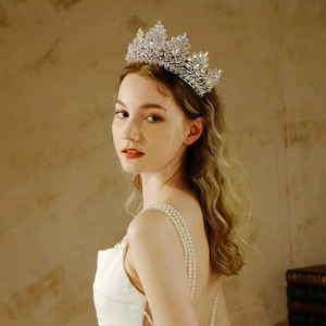 Detailed side view of a bridal tiara with marquis crystals on a model in white dress