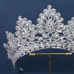 Macro shot of bridal crown with silver crystals on a display stand with dark background