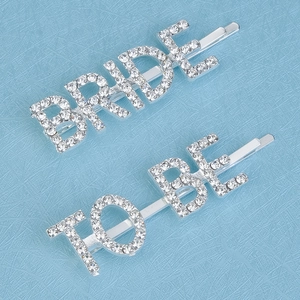 Macro detail of silver bride to be hair pins with sparkling rhinestones for wedding