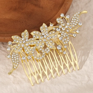 Detail of bridal hair comb with gold alloy floral patterns and white rhinestones