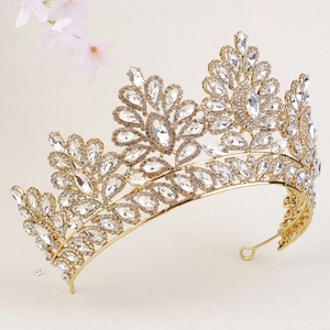 Macro detail of a golden bridal crown featuring intricate floral leaf crystal settings