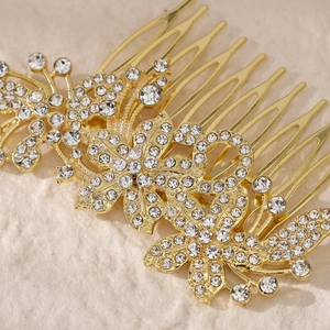 Close-up of golden floral bridal hair comb with shimmering rhinestones and intricate details