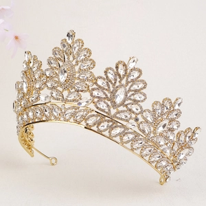 Detailed side view of golden bridal tiara with sparkling crystal leaves and rhinestones