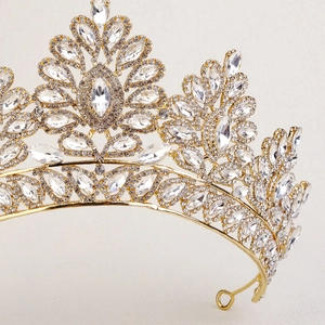 Close-up of golden Baroque bridal crown with intricate crystals and sparkling rhinestones