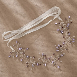 Detail of silver twisted wire bridal headband with purple crystals and white chiffon ribbon