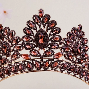 Macro detail of Baroque crown featuring deep red rhinestones and intricate alloy metalwork