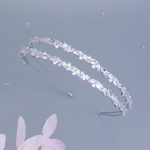 Detail view of crystal zircon bridal headband with silver leaf pattern on grey background