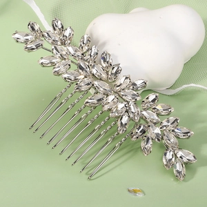 Detail of bridal hair comb with marquise crystals and silver leaf branch design