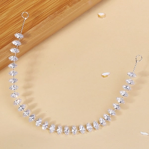 Detail of marquise-cut cubic zirconia hair chain with silver-tone metal links for brides