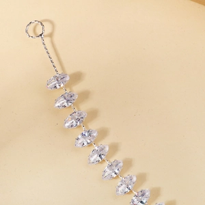 Minimalist marquise zircon headband with silver metal chain on warm beige background