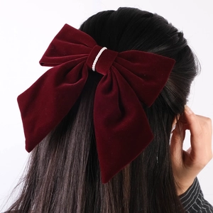 Detailed back view of a burgundy velvet bow hair clip featuring elegant pearl center accents