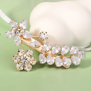 Elegant gold flower hair clip with sparkling white zircon crystals in a floral motif