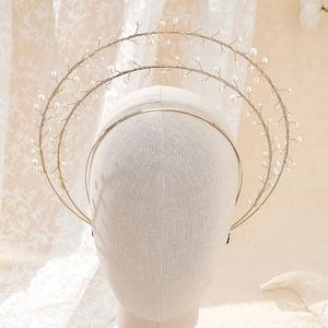 Detail of handmade gold wire halo crown featuring radiating white pearls for women