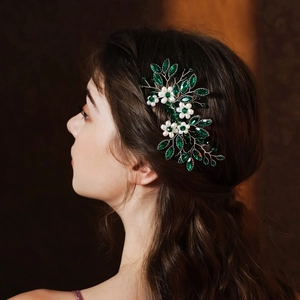 Detailed bridal hair comb with green marquise stones and white pearls on silver wire