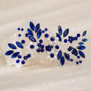 Detailed macro view of handmade bridal hair comb with blue crystals and white pearls