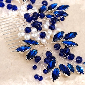 Detail of bridal hair comb with deep blue crystals and white pearls on silver wire