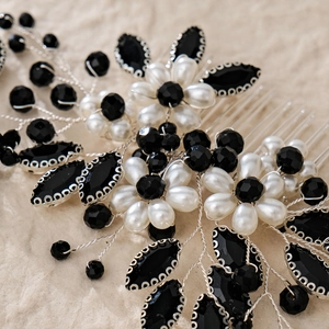 Close-up of handmade bridal hair comb featuring white pearls and black rhinestones