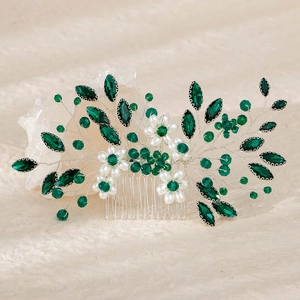 Detailed macro of handmade bridal hair comb with green crystals and white pearls