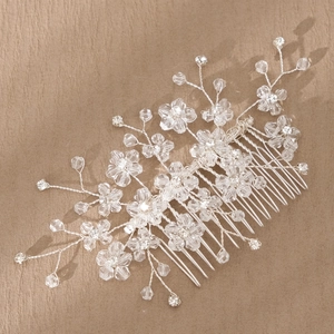 Detailed macro view of handmade silver bridal hair comb with transparent crystal flowers