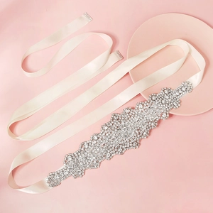 Elegant bridal wedding sash with silver rhinestone floral applique on off-white ribbon