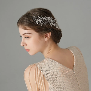 Detailed side view of handmade bridal hair comb with crystals, pearls and silver vine design