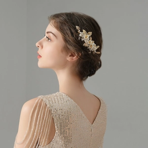 Detailed side view of handmade bridal hair comb with pearls and golden leaves