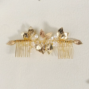 Golden bridal hair comb with elegant metal leaves and white pearls for wedding styling