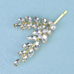 Elegant gold leaf hair clip with marquise rhinestones and white pearls for bridal styling