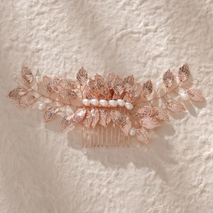 Detail view of rose gold leaf hair comb with white pearls and delicate veins
