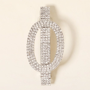 Close-up of geometric rhinestone hair clip with silver metal spring mechanism
