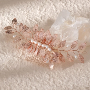 Handmade bridal hair comb with rose gold leaves and white pearls for elegant weddings