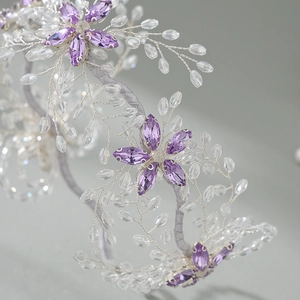 Handmade bridal headband featuring purple crystal flowers and silver beaded leaves