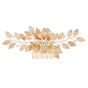 Handmade golden bridal hair comb featuring delicate metal leaves and white pearls
