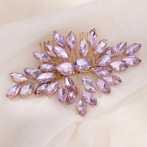 Detailed view of bridal hair comb with purple crystals on silk fabric background