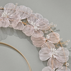 Elegant bridal headband featuring triple-layered white floral petals and gold leaf accents