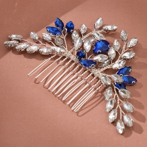 Macro shot of silver bridal hair comb with deep blue and clear marquise rhinestones