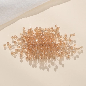 Detail of handmade champagne crystal hair comb with gold wire and faceted beads
