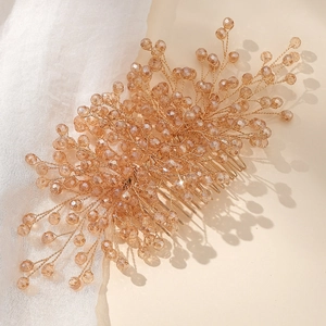 Macro detail of bridal hair comb featuring champagne crystals and golden wire beads