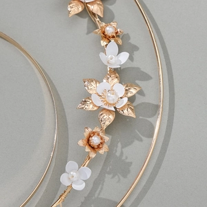 Elegant gold metal floral headpiece with white petals and pearls for fashion photography