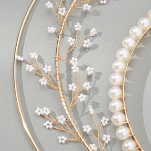Elegant bridal headband with handcrafted white pearls and golden metallic leaf details