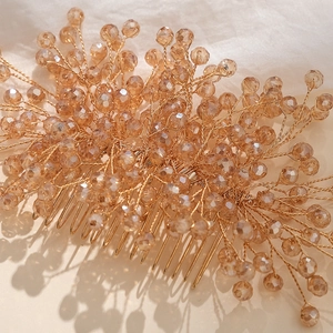 Detail of handmade champagne crystal hair comb with golden wire and amber beads