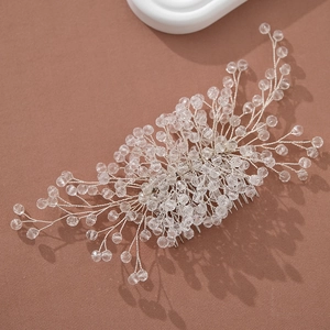 Detail of a handmade bridal hair comb with champagne crystals and silver wire branches