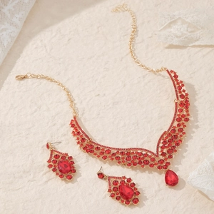 Luxury gold necklace and earrings set with red pear-shaped rhinestones for bridal party