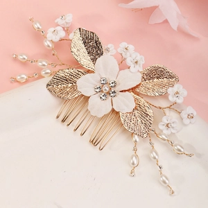 Elegant gold bridal hair comb with white fabric flowers and pearl accents for weddings