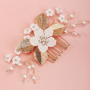 Bridal hair comb with white fabric flower, pearls and gold leaves for wedding hairstyles