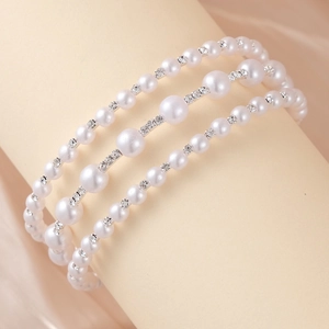 Detail view of triple-layer pearl bracelet with rhinestones on elegant display stand