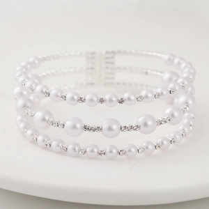 Elegant three-layer faux pearl bracelet with sparkling rhinestone spacers on white tray