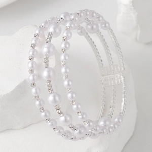 Macro detail of elegant three-row pearl bracelet with sparkling crystal rhinestones