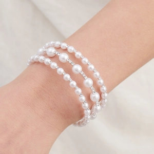 Elegant triple-layer pearl bracelet for women featuring sparkling crystal spacers on wrist